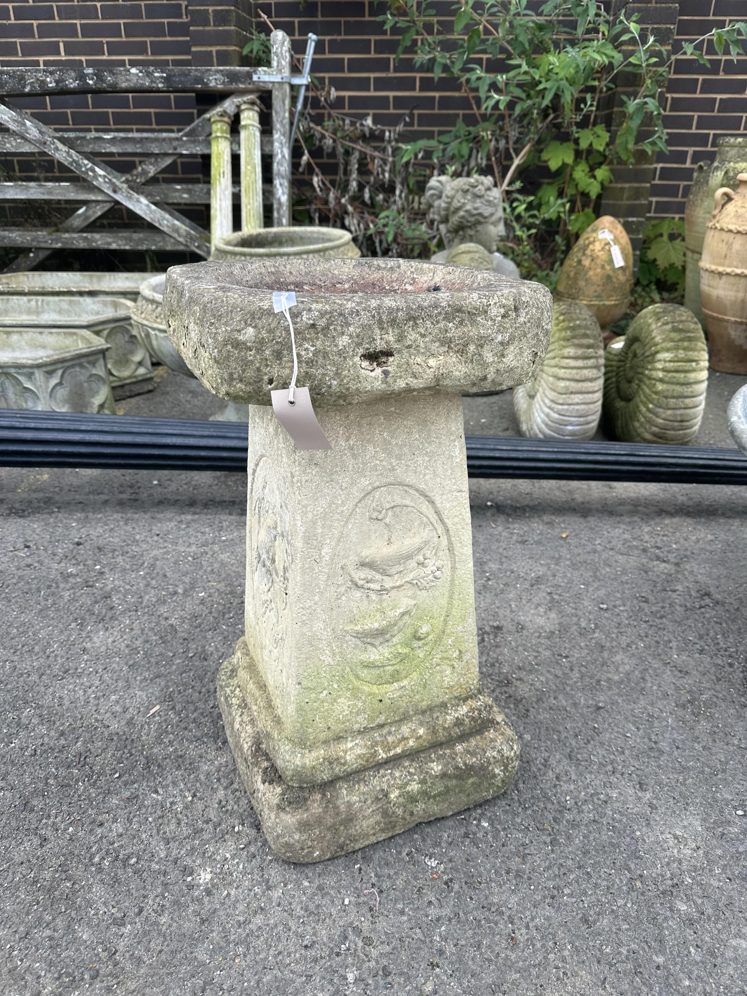 A reconstituted stone bird bath on square pedestal, width 36cm, height 65cm. Condition - fair